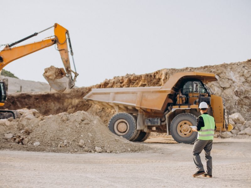 Male worker with bulldozer in sand quarry